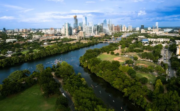 The downtown Austin skyline above the Colorado River greenbelt, the backdrop for West Austin 78703 neighborhoods like Tarrytown and Clarksville